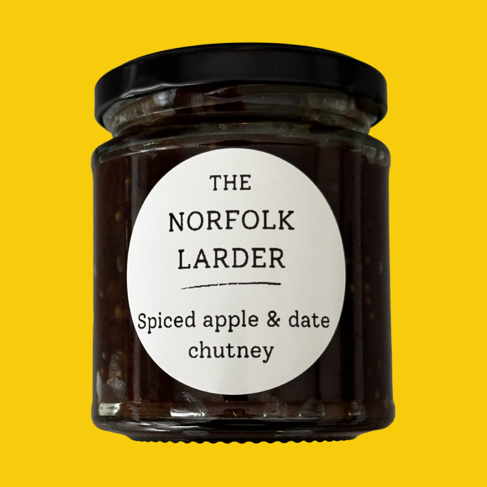 A jar of Norfolk Larder spiced apple & date chutney on a yellow background