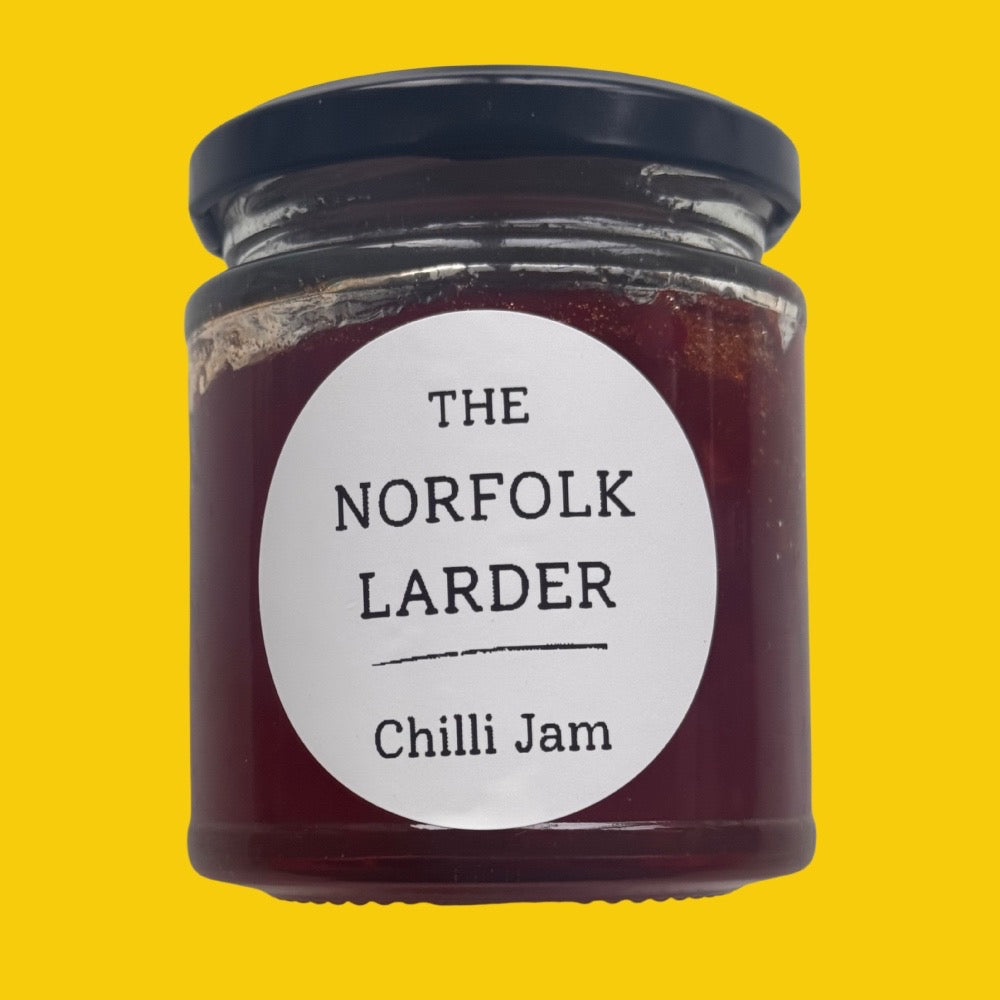 a 180g jar of Norfolk Larder Chilli Jam on a yellow backgriund