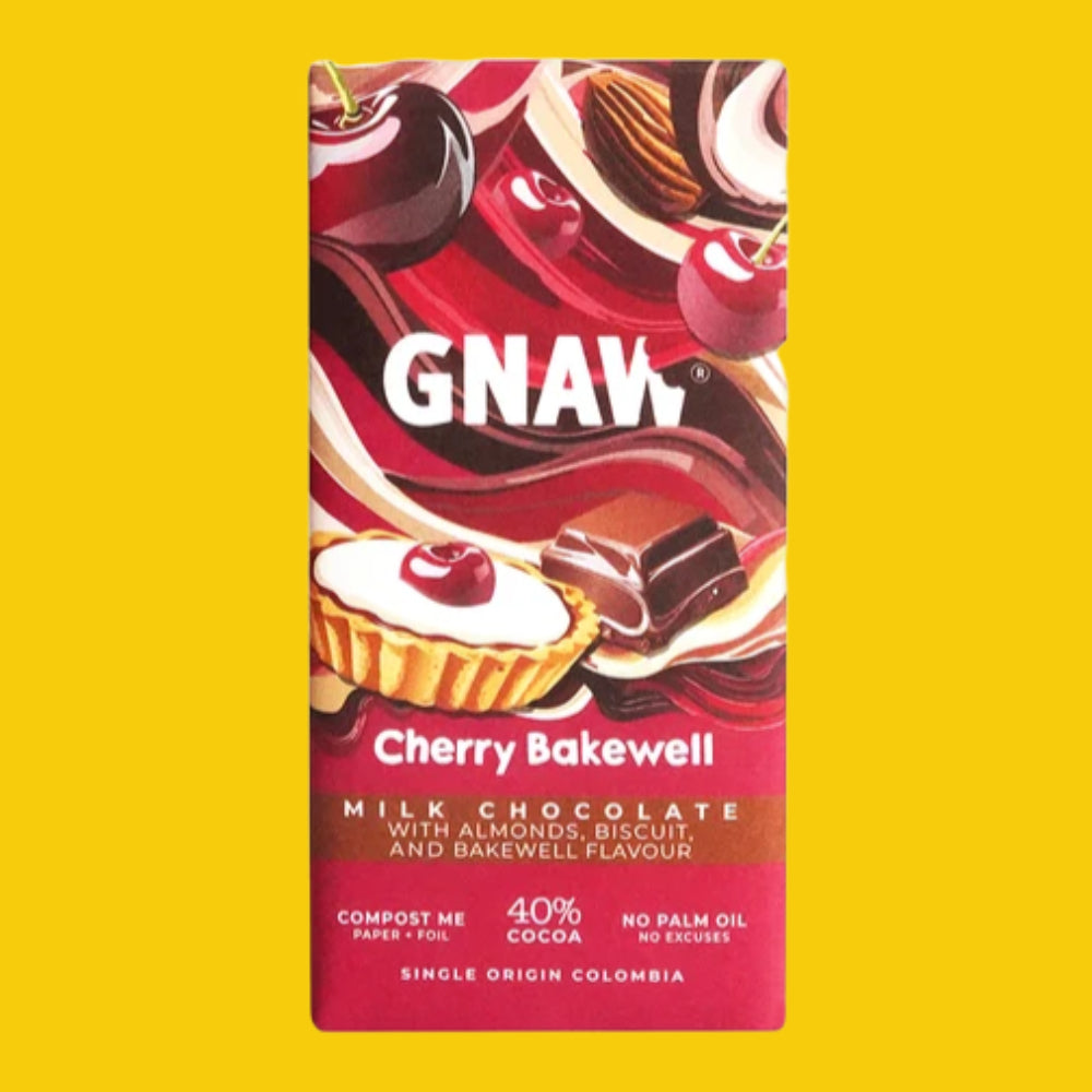 A bar of GNAW Cherry Bakewell chocolate with milk chocolate, almonds, biscuit, and cherries, shown in its packaging against a solid yellow background.