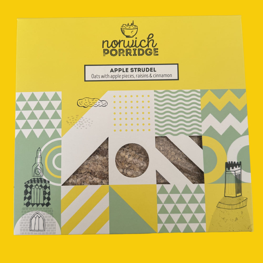 A square yellow box of Norwich Porridge Apple Strudel, featuring a window that reveals the brown oatmeal product inside. The packaging has a bright yellow background with green, white, and yellow geometric patterns and illustrations of a teapot and a jar of raisins.