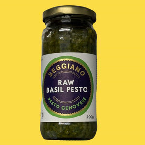 Raw basil pesto on a yellow background